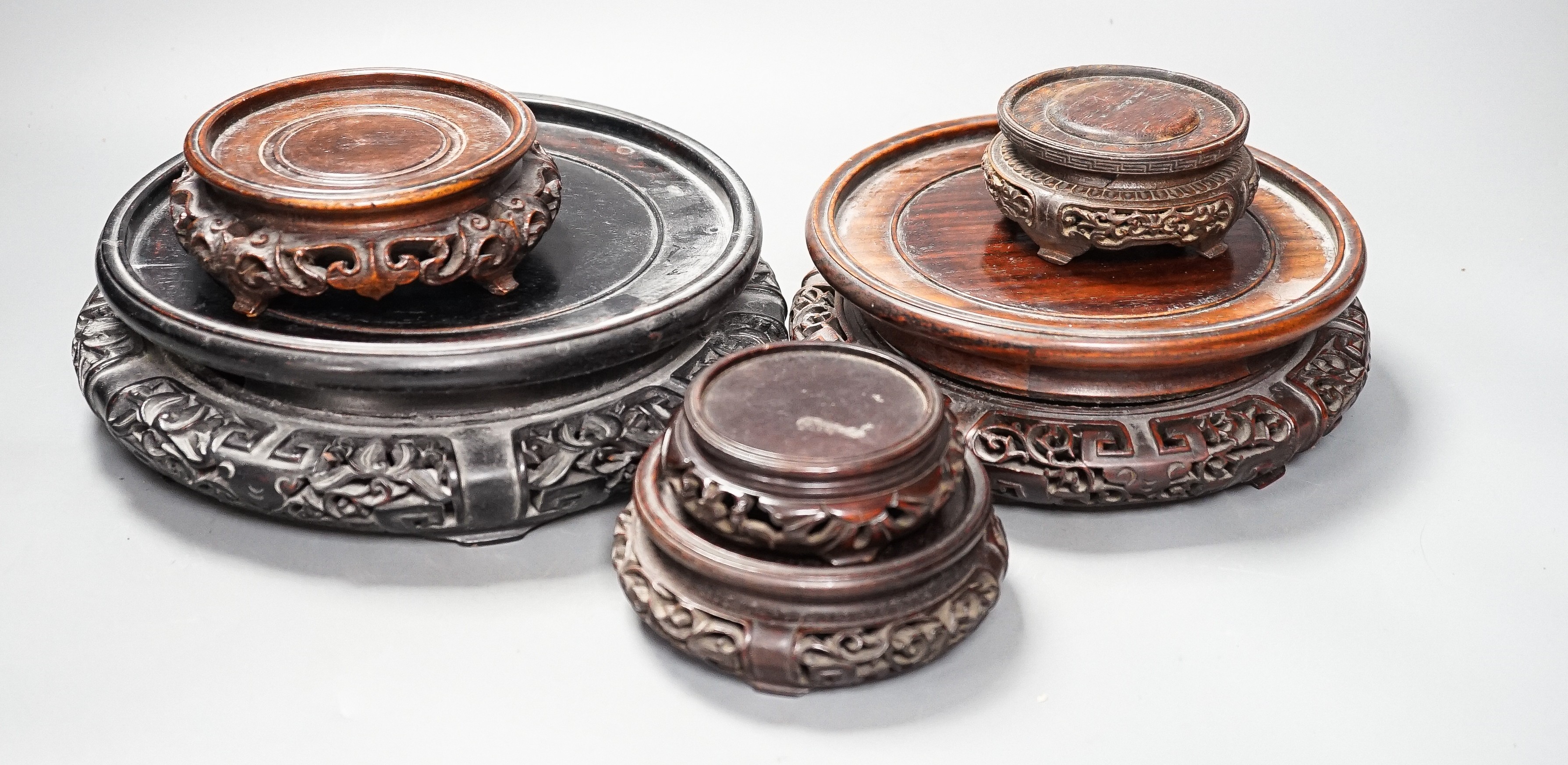 A collection of Chinese hardwood stands, largest 23. 5 cm